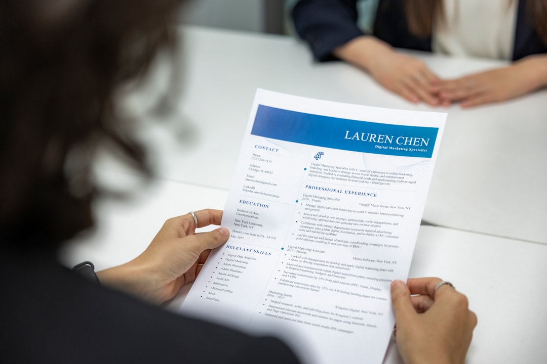 Hands holding a printed resume