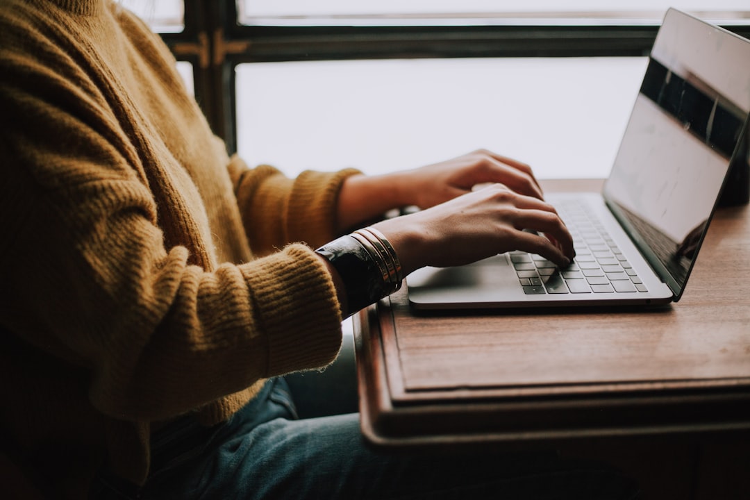 Person working on a laptop at a desk